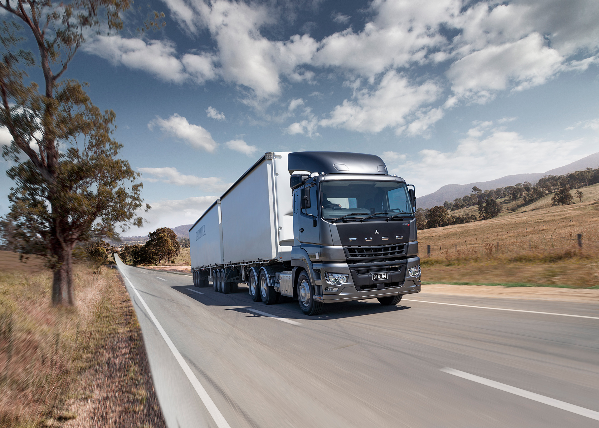 retouched image of Fuso b double truck on a country road